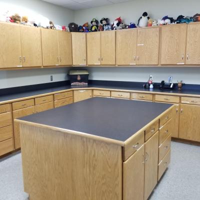 top and bottom line of cabinets with an island in the foreground